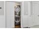 Laundry closet with a stacked washer and dryer behind folding louvered doors at 157 9Th N Ave, St Petersburg, FL 33701