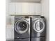 This laundry room features a washer, dryer, white cabinets, and a sink at 157 9Th N Ave, St Petersburg, FL 33701