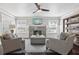 Inviting living room featuring a stone fireplace, large windows, and comfortable seating, perfect for relaxation at 157 9Th N Ave, St Petersburg, FL 33701