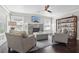 Comfortable living room features a stone fireplace, large windows, and sleek dark hardwood floors at 157 9Th N Ave, St Petersburg, FL 33701