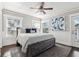 Bright main bedroom featuring a wooden bedframe, grey rug, and natural light from multiple windows at 157 9Th N Ave, St Petersburg, FL 33701