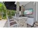 This outdoor kitchen features a built-in grill, sink, counter seating, and a mounted flat screen tv at 157 9Th N Ave, St Petersburg, FL 33701