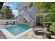 This backyard pool features a waterfall feature and lounge seating at 157 9Th N Ave, St Petersburg, FL 33701