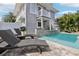 Backyard pool and deck with lounge seating and lush tropical landscaping at 157 9Th N Ave, St Petersburg, FL 33701