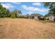 Wide shot of backyard featuring green trees and ample space at 15810 Starling Water Dr, Lithia, FL 33547