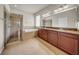 Well-lit bathroom features a double vanity, soaking tub, and a glass-enclosed shower at 15810 Starling Water Dr, Lithia, FL 33547