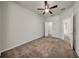 Carpeted bedroom featuring a ceiling fan, with an en-suite and walk-in closet access at 15810 Starling Water Dr, Lithia, FL 33547