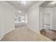 Open foyer showcases neutral walls and a smooth transition to carpeted living spaces at 15810 Starling Water Dr, Lithia, FL 33547