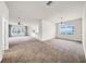 Open-concept living area with abundant natural light and smooth carpet flooring at 15810 Starling Water Dr, Lithia, FL 33547