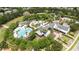 Aerial view of the community pool and surrounding trees and buildings at 15810 Starling Water Dr, Lithia, FL 33547