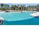 Resort-style community pool area with ample seating, shade, and clear blue water at 1724 Longliner Loop, Wesley Chapel, FL 33543
