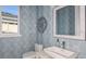Stylish half bathroom with geometric wallpaper, modern vanity, square sink, and decor at 1738 Longliner Loop, Wesley Chapel, FL 33543