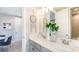 Bathroom featuring a double vanity with gray cabinets, neutral walls, and a decorative mirror at 1738 Longliner Loop, Wesley Chapel, FL 33543