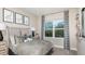 Well-lit bedroom features neutral walls, carpet, dinosaur-themed prints, and gray patterned bedding at 1738 Longliner Loop, Wesley Chapel, FL 33543