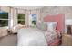 Cheerful bedroom featuring unique accent wall, lots of natural light and stylish decor at 1738 Longliner Loop, Wesley Chapel, FL 33543