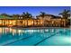 Community pool featuring a clear swimming area, lounge chairs, and elegant architecture in the surrounding buildings at 1738 Longliner Loop, Wesley Chapel, FL 33543