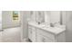 Bathroom featuring double sinks, a large mirror, and a door leading to the bedroom at 20417 Symphony Pl, Venice, FL 34293