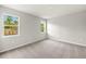 Bright bedroom features carpeted floors and windows that offer backyard views at 20417 Symphony Pl, Venice, FL 34293