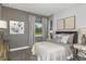 A serene bedroom features two windows, neutral gray paint and carpet, and stylish lamps at 20417 Symphony Pl, Venice, FL 34293