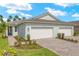 Charming single-story home boasts a well-manicured lawn, paved driveway, and a convenient two-car garage at 20417 Symphony Pl, Venice, FL 34293