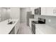Modern kitchen features stainless steel appliances, quartz countertop, and sleek cabinetry at 20417 Symphony Pl, Venice, FL 34293