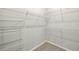 A well-organized walk-in closet offers ample storage with its multiple wire shelves at 20417 Symphony Pl, Venice, FL 34293