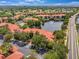 Aerial view of the community buildings and recreation areas with a lake nearby at 2400 Feather Sound Dr # 1136, Clearwater, FL 33762