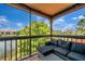 The screened-in patio features a modern outdoor seating area with a view of the lake at 2400 Feather Sound Dr # 1136, Clearwater, FL 33762