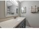 Bathroom with a sink and cabinets and a mirror, plus towel rack at 2400 Feather Sound Dr # 1136, Clearwater, FL 33762