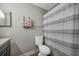 This is a bathroom with a toilet, shower with curtain and sink with cabinets at 2400 Feather Sound Dr # 1136, Clearwater, FL 33762