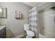 This is a bathroom with a toilet, shower with curtain and sink with cabinets at 2400 Feather Sound Dr # 1136, Clearwater, FL 33762