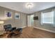 Inviting bedroom with wood floors, a chair with ottoman, a window, and ensuite closet at 2400 Feather Sound Dr # 1136, Clearwater, FL 33762