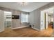 Bedroom showcasing the closet and bathroom featuring wood-look floors and a stylish light fixture at 2400 Feather Sound Dr # 1136, Clearwater, FL 33762