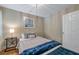 Cozy bedroom is staged with a comfortable bed, stylish lighting, and neutral decor at 2400 Feather Sound Dr # 1136, Clearwater, FL 33762