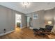 Bright bedroom features wood floors, a modern chair with ottoman, and ensuite bathroom access at 2400 Feather Sound Dr # 1136, Clearwater, FL 33762