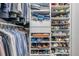 This is a closet with shelving, rods, and clothing, and shoes at 2400 Feather Sound Dr # 1136, Clearwater, FL 33762