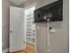 Walk-in closet with wall-mounted tv and custom shelving for optimum storage solutions at 2400 Feather Sound Dr # 1136, Clearwater, FL 33762