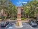 Exterior view of a building with mature landscaping and nearby parking at 2400 Feather Sound Dr # 1136, Clearwater, FL 33762