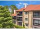 Exterior view showing several levels of screened patios with a red tile roof at 2400 Feather Sound Dr # 1136, Clearwater, FL 33762