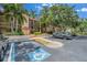 Exterior view of a building with mature landscaping and nearby parking at 2400 Feather Sound Dr # 1136, Clearwater, FL 33762