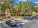 Exterior view of a building with mature landscaping and nearby parking at 2400 Feather Sound Dr # 1136, Clearwater, FL 33762