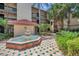 Exterior shot of building with landscaping featuring a three-tiered fountain at 2400 Feather Sound Dr # 1136, Clearwater, FL 33762