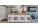 Large kitchen island with white cabinets, granite countertops, seating for four and stainless steel appliances at 2400 Feather Sound Dr # 1136, Clearwater, FL 33762