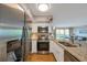 Well-lit kitchen with stainless steel appliances, granite countertops and wood flooring overlooking the living space at 2400 Feather Sound Dr # 1136, Clearwater, FL 33762