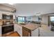Kitchen with stainless steel appliances, a breakfast bar and an opening to the living room at 2400 Feather Sound Dr # 1136, Clearwater, FL 33762