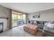 Bright living room area with a large couch, decorative pillows, an outdoor balcony and fireplace at 2400 Feather Sound Dr # 1136, Clearwater, FL 33762