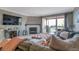 Comfortable living room area with a large couch, outdoor balcony, television, and fireplace at 2400 Feather Sound Dr # 1136, Clearwater, FL 33762