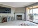 Bright living room with a television, fireplace, candles and an outdoor balcony with a grill at 2400 Feather Sound Dr # 1136, Clearwater, FL 33762