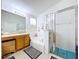 Well-lit bathroom featuring a bathtub, standing shower, and wooden cabinets at 24305 Denali Ct, Lutz, FL 33559
