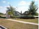 Oak Grove community entrance featuring lush landscaping, brick accents, and serene views at 24305 Denali Ct, Lutz, FL 33559